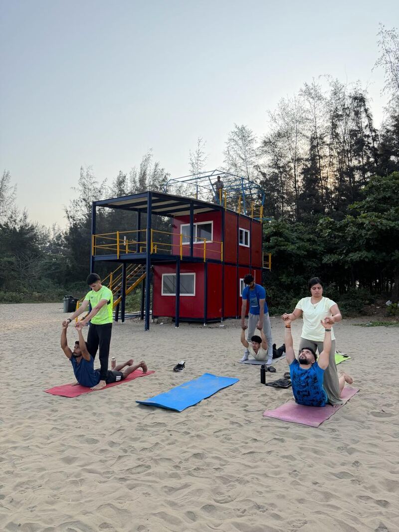 Partner asana practice on the beach